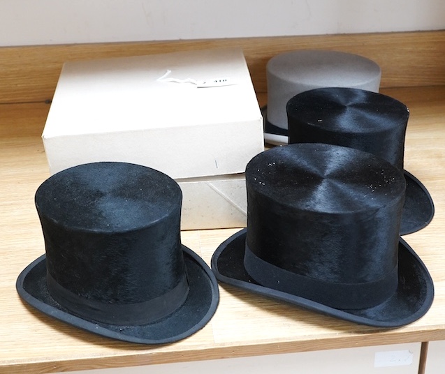 Three gentlemen’s black silk top hats and a similar grey top hat and box. Condition - grey hat good, others poor